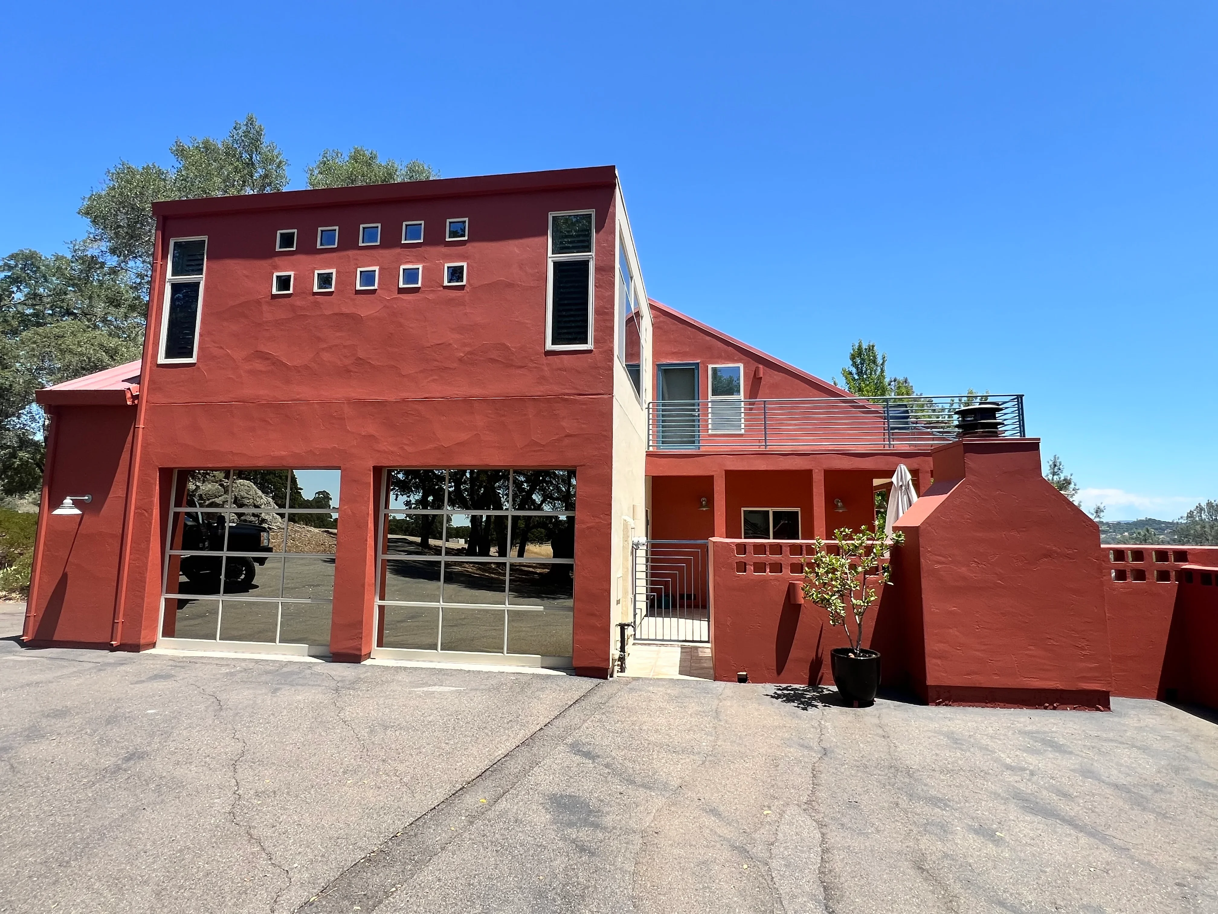 Modern red and cream commercial building with painted stucco exterior and large garage doors